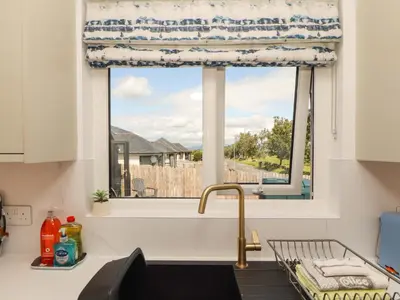 a kitchen with a sink and a window with a view at The Paddock in Kirkcowan