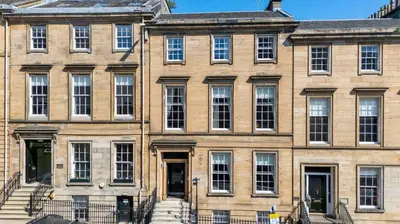 a large brick building with stairs in front of it at Cairn BNB Introduces Blythswood Apartments - Experience exceptional luxury living in Glasgow's most desirable location in Glasgow