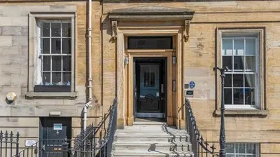 a building with a black door and stairs in front at Cairn BNB Introduces Blythswood Apartments - Experience exceptional luxury living in Glasgow's most desirable location in Glasgow