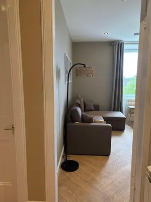 a living room with a couch and a floor lamp at Central Oban 2BR Short walk to Ferries and Harbour in Oban