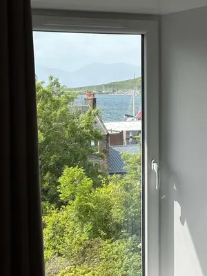 a window with a view of a body of water at Central Oban 2BR Short walk to Ferries and Harbour in Oban