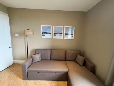 a couch in a living room with three pictures on the wall at Central Oban 2BR Short walk to Ferries and Harbour in Oban