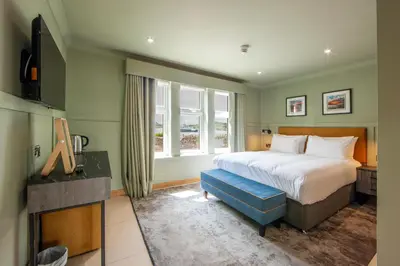 a bedroom with a large bed and a window at Oban House House in Oban