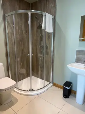 a shower in a bathroom with a toilet and a sink at Oban House House in Oban