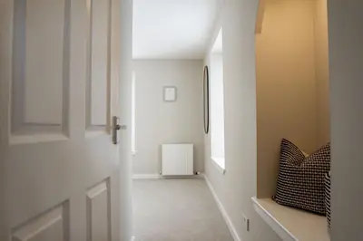a hallway with a white door and a window at Cottage in Crieff in Crieff