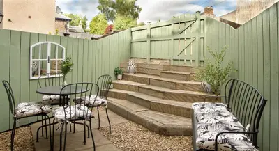 a patio with chairs and a table and stairs at Cottage in Crieff in Crieff