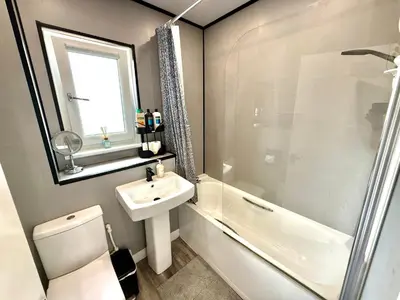 a bathroom with a sink and a toilet and a shower at South Gyle House - SuperFast WiFi and Free Parking - 7 minutes from Edinburgh Airport in Edinburgh