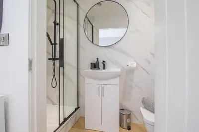 a bathroom with a sink and a mirror at Alexandra Apartment - Single Room #1 in Falkirk