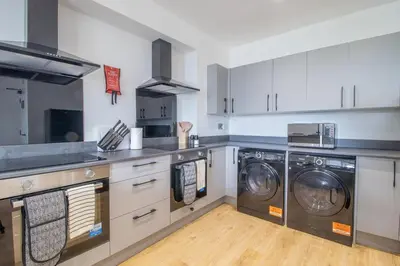 a kitchen with two washers and two washers at Alexandra Apartment - Single Room #1 in Falkirk