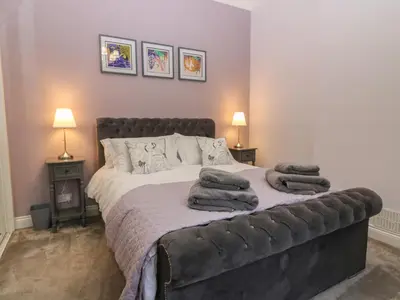 a bedroom with a bed with towels on it at 60E Wellgate in Lanark