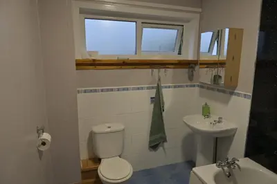 a bathroom with a toilet and a sink at Stylish Coastal Retreat in Saltcoats in Stevenston