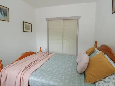 a bedroom with a bed and a white door at Bathach Mor in Oban