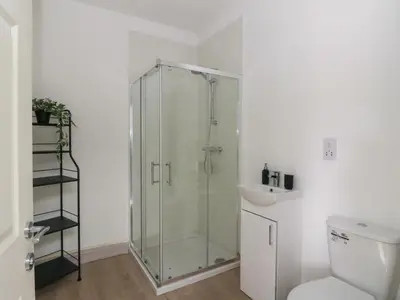a bathroom with a shower and a toilet and a sink at Bathach Mor in Oban