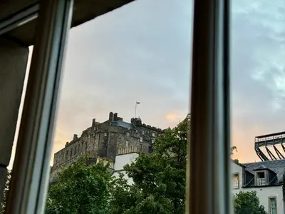 a view of a castle from a window at Stylish 2BR Grassmarket Flat with Castle Views & PS5 in Edinburgh
