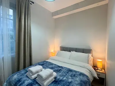a bedroom with a bed with towels on it at Stylish 2BR Grassmarket Flat with Castle Views & PS5 in Edinburgh