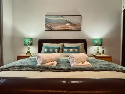 a bedroom with a bed with two towels on it at Stylish 2BR Grassmarket Flat with Castle Views & PS5 in Edinburgh
