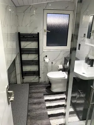 a bathroom with a toilet and a sink and a window at Luxury House in Glasgow in Mansewood