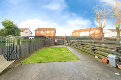 a backyard with a fence and a yard with grass at Luxury House in Glasgow in Mansewood