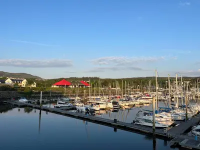 a bunch of boats are docked in a marina at Coastal Village Property in Inverkip
