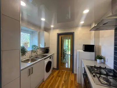 a kitchen with a sink and a washing machine at Coastal Village Property in Inverkip