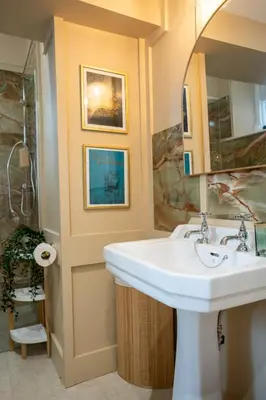 a bathroom with a sink and a mirror at Penninghame Estate - Earl's Library in Challoch