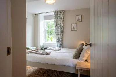 a bedroom with a bed and a window at Penninghame Estate - Earl's Library in Challoch