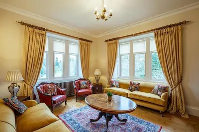 a living room with two couches and a table at Penninghame Estate - Tower Apartment in Challoch