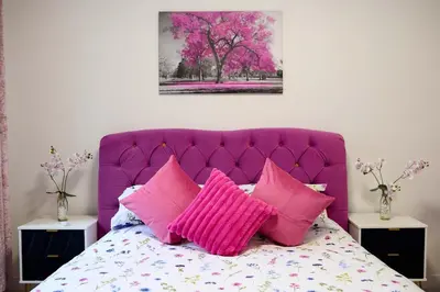 a purple bed with pink pillows in a bedroom at Stunning 2BR Apt - Central High Street Location in Oban