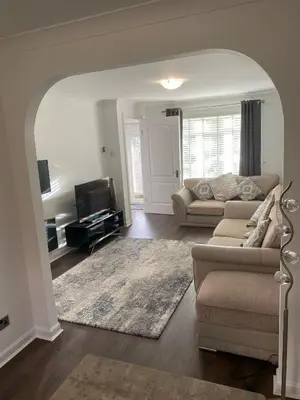a living room with a couch and a tv at Millview house in Airdrie