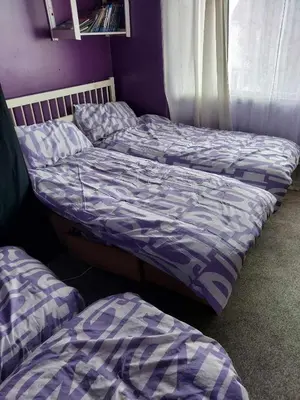 three beds in a room with purple walls at Silverknowes in Edinburgh