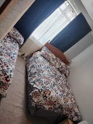 two beds sitting next to a window in a room at Silverknowes in Edinburgh