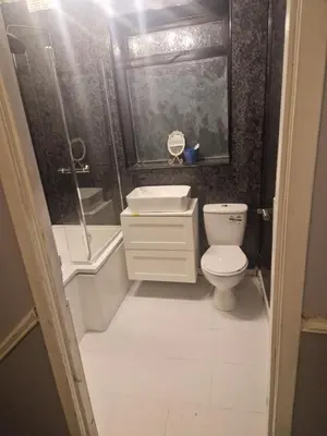 a bathroom with a toilet and a shower and a sink at Silverknowes in Edinburgh