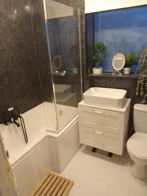 a bathroom with a shower and a toilet and a sink at Silverknowes in Edinburgh