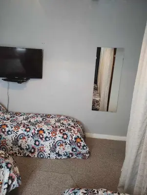 a bedroom with a bed and a flat screen tv at Silverknowes in Edinburgh