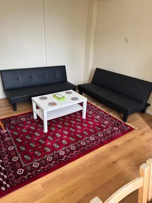a living room with a couch and a coffee table at Your Base To Explore London in Moffat