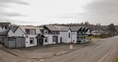 a row of houses on the side of a street at Oyster Inn Connel in Oban