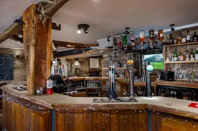 a bar with a wooden counter top in a pub at Oyster Inn Connel in Oban