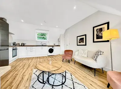 a living room with a couch and a table at Cuan Flat - Oban in Oban
