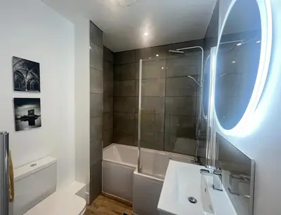 a bathroom with a shower and a sink and a tub at Cuan Flat - Oban in Oban