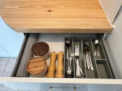 a drawer filled with utensils in a kitchen at Self-contained ground level cottage with hill view in Edinburgh