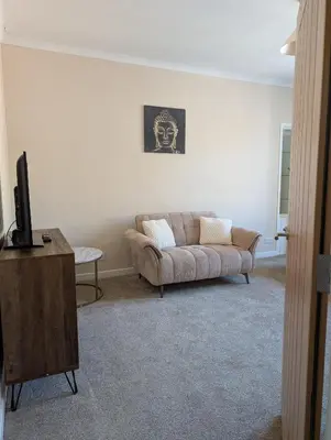 a living room with a couch and a tv at Kirk street apartment in Campbeltown