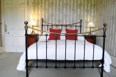 a bedroom with a bed with red pillows at The South Wing in Acharn