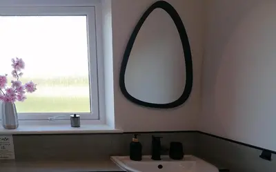 a bathroom with a mirror and a sink and a window at Entire Spacious 3-Bed Family Home, City Centre, Free Parking, Garden in Glasgow