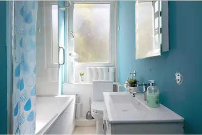 a bathroom with a sink and a toilet and a window at Edinburgh Drumdryan Central Apart in Edinburgh