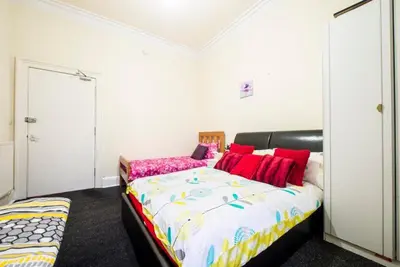 a bedroom with a large bed with red pillows at Edinburgh Central Morrison Apartment in Edinburgh