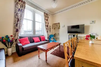 a living room with a couch and a table at Edinburgh Central Morrison Apartment in Edinburgh