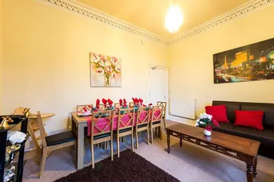 a living room with a table and chairs and a couch at Edinburgh Central Morrison Apartment in Edinburgh