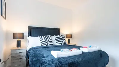 a bedroom with a bed with two towels on it at Craigseaton House in Broxburn