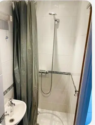 a bathroom with a shower curtain and a sink at Bank West in Edinburgh
