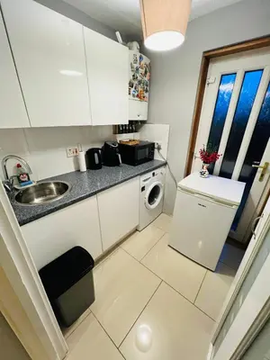 a small kitchen with a sink and a dishwasher at Bank West in Edinburgh